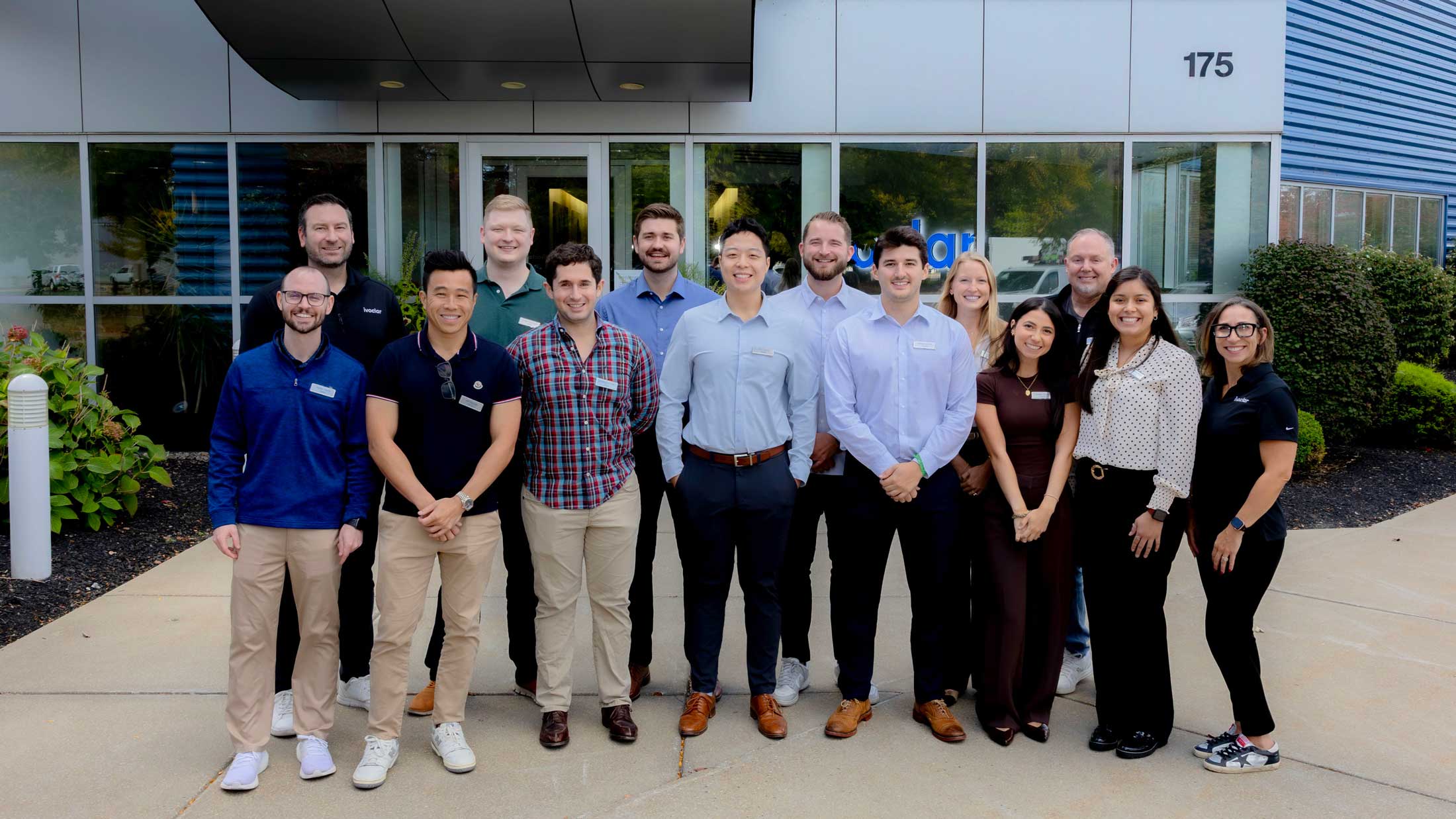 Group photo of dentists in front of an office building preparing to attend the Pearl Street Doctor Academy.
